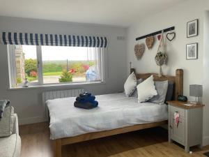 a bedroom with a bed with a teddy bear on it at West Moor View Apartment in Launceston