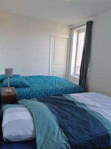 Posteľ alebo postele v izbe v ubytovaní logement entier spacieux et confortable à 1 h de Paris