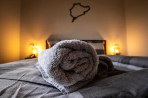 a towel is sitting on top of a bed at Südschleife Appartements - App. 2 - WLAN - Direkt am Ring in Reimerath