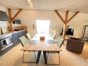 a dining room table and chairs in a kitchen at Ferienwohnungen Meerhuus_ 45229 in Ditzum