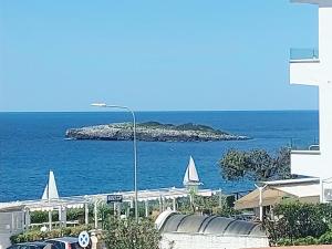 a view of an island in the ocean with a street light at Don Mario Aparthotel & Rooms in Marina di Camerota