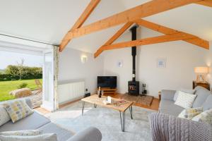 a living room with a couch and a table at Cobblestone Cottage in Penzance