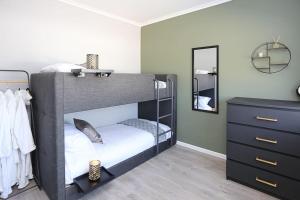 a small bedroom with a bunk bed and a dresser at Briglane Cottage in Kirkistown