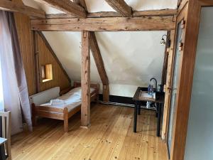 a small room with a bed and a table at Kapteinis in Liepāja