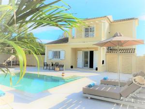 a villa with a swimming pool and a house at My Corfu Luxury Villa with private pool at Sidari in Sidari