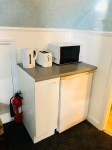 a microwave sitting on top of a counter at AC Hideout in Rochford