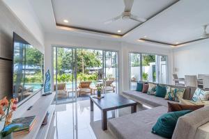 a living room with a couch and a table at BALANCE BEACH VILLA in Koh Samui 