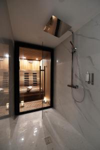 a bathroom with a shower and a window in it at Empreinte Hotel & Spa in Orléans