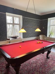 a red pool table in a room at Tullesbo Sätesgård in Sjöbo