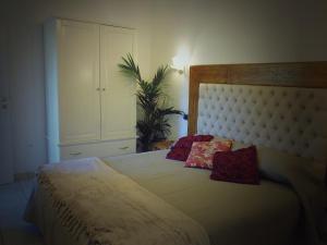 a bedroom with a large bed with two pillows on it at Villa il Poderino in Marina di Campo