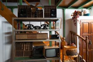 a room with a shelf with a tv in it at Architect Art Studio in Athens