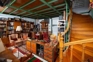 a living room with a staircase and a room with books at Architect Art Studio in Athens