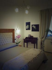 a bedroom with a bed and a table with a desk at Villa il Poderino in Marina di Campo