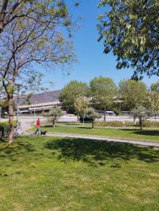 a person walking a dog in a park at Bella Vista - cozy apartments with easy check-in and free parking in Split +32 photos