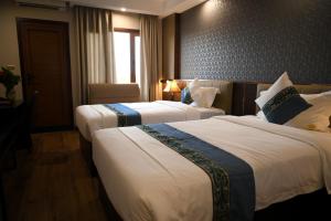 En eller flere senge i et værelse på 东都明月酒店Dong Do Minh Nguyet