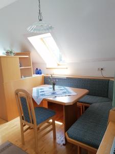 a dining room with a table and two chairs at Ursprunghof in Zeutschach