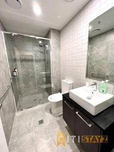 a bathroom with a shower and a sink and a toilet at Fab in Phillip - 2bd 2bth Apt - Close to CBR Hospital in Phillip