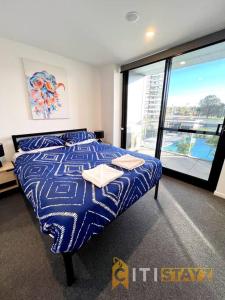 a bedroom with a bed and a large window at Fab in Phillip - 2bd 2bth Apt - Close to CBR Hospital in Phillip