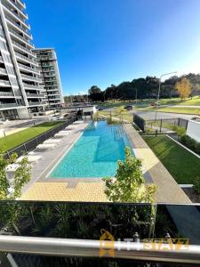 a large swimming pool in the middle of a building at Fab in Phillip - 2bd 2bth Apt - Close to CBR Hospital in Phillip