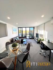 a living room with a glass table and chairs at Fab in Phillip - 2bd 2bth Apt - Close to CBR Hospital in Phillip