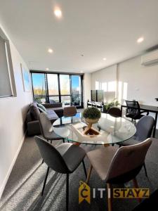 a living room with a table and chairs at Fab in Phillip - 2bd 2bth Apt - Close to CBR Hospital in Phillip