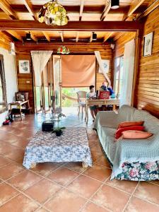 a living room with a couch and a table at Rang Robin Farmstay for 4 with pool in Ban Wang Muang