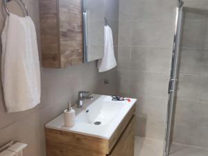 a bathroom with a sink and a shower at Fioravante in Argostoli