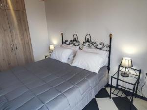 a bedroom with a large bed with white pillows at Fioravante in Argostoli