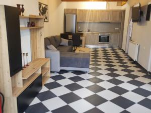 a living room with a couch and a checkered floor at Fioravante in Argostoli