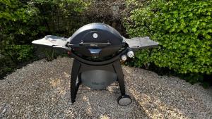 a grill sitting on the ground with a helmet on it at PURE - Chalet Zeeland - garden out of sight in Hoek