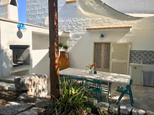 a patio with a table and chairs in a house at Villa Dèco Monopoli in Monopoli