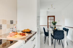 a kitchen with a table with a plate of food on it at The Serenity, Three bedroom house, Preston in Walton le Dale