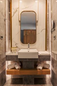 a bathroom with a sink and a mirror at BIO BEACH Boutique Hotel - Adults Only in Rethymno
