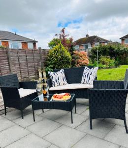 a patio with two chairs and a couch and a table at The Serenity, Three bedroom house, Preston in Walton le Dale