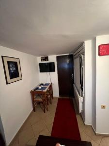 a small room with a table and a television at E & V free wi fi in Podgorica