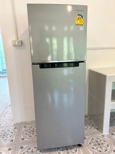 a stainless steel refrigerator sitting in a kitchen at Modern Sunset Sea House Lam Sai in Ko Yao Noi