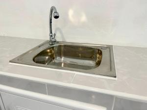 a silver sink with a faucet on a counter at Modern Sunset Sea House Lam Sai in Ko Yao Noi