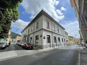 a white building on the side of a street at SH Accademia in Carrara