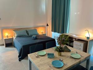 a bedroom with a bed and a table with plates on it at SH Accademia in Carrara