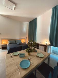 a living room with a table and a couch at SH Accademia in Carrara