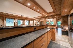 a kitchen with wooden cabinets and a large island at Le Chalet des Ours in Megève