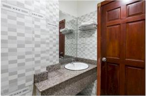 a bathroom with a sink and a mirror at OYO 1117 Ngoc Lan Motel in Hue