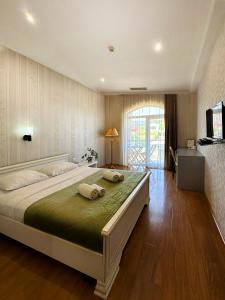 a bedroom with a large bed with two towels on it at - Granada - Boutique Hotel - Tbilisi - in Tbilisi City