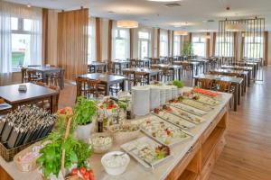 a buffet line with plates of food in a restaurant at Mona Lisa Wellness & Spa in Kołobrzeg