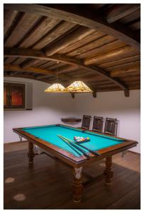 a pool table in a living room with a ceiling at Mona Lisa Wellness & Spa in Kołobrzeg