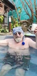 a man in a swimming pool wearing a hat and sunglasses at Home&Classic - Alte Werkstatt in Effelder