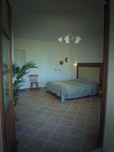 a bedroom with a bed and a table and a chair at Villa il Poderino in Marina di Campo