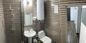 a bathroom with a toilet and a sink at Garsoniera la malul marii in Mangalia