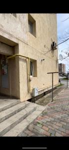 a building with a door and stairs in front of it at Garsoniera la malul marii in Mangalia