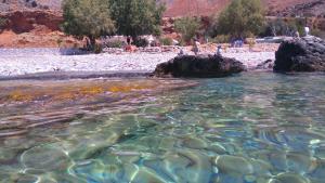 a body of water with a bunch of rocks at Georgoshouse Lykos beach Sfakia in Livanianá